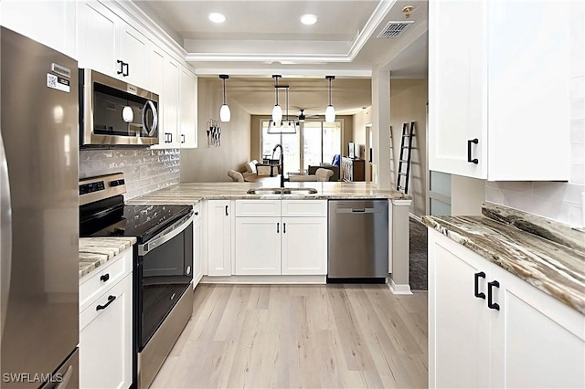 14911 Hole In 1 Cir Unit 310, Fort Myers, FL 33919 - kitchen with appliances with stainless steel finishes, a sink, light wood-style flooring, light stone counters, and backsplash