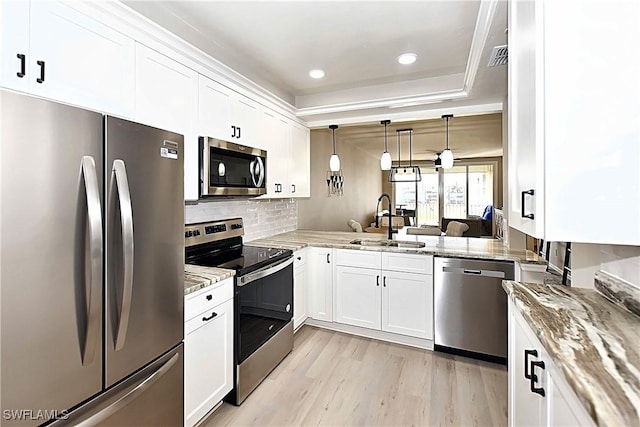 14911 Hole In 1 Cir Unit 310, Fort Myers, FL 33919 - kitchen featuring appliances with stainless steel finishes, a sink, light wood-style floors, light stone countertops, and recessed lighting