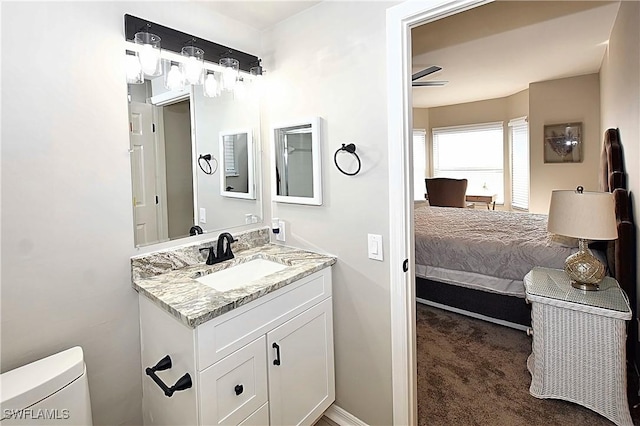 14911 Hole In 1 Cir Unit 310, Fort Myers, FL 33919 - bathroom with toilet, vanity, baseboards, and ceiling fan