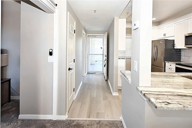 14911 Hole In 1 Cir Unit 310, Fort Myers, FL 33919 - hallway featuring baseboards and light wood-style flooring