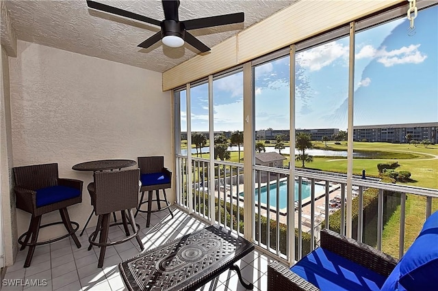 14911 Hole In 1 Cir Unit 310, Fort Myers, FL 33919 - sunroom with view of golf course and a water view