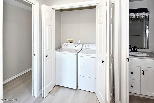 14911 Hole In 1 Cir Unit 310, Fort Myers, FL 33919 - laundry area with separate washer and dryer and light wood-style floors