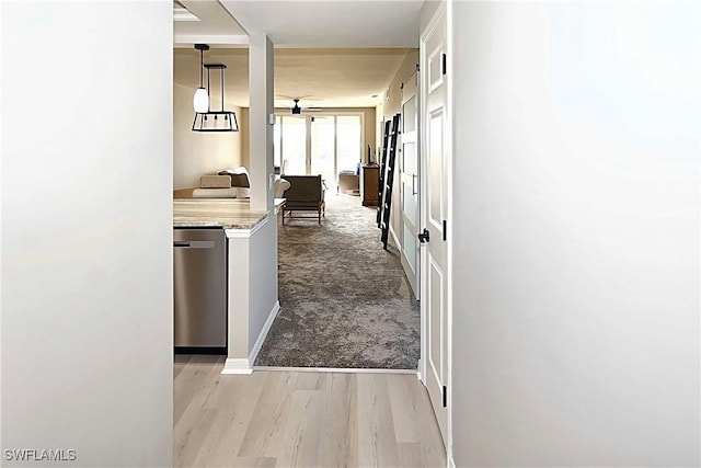 14911 Hole In 1 Cir Unit 310, Fort Myers, FL 33919 - corridor with light carpet, light wood finished floors, and baseboards