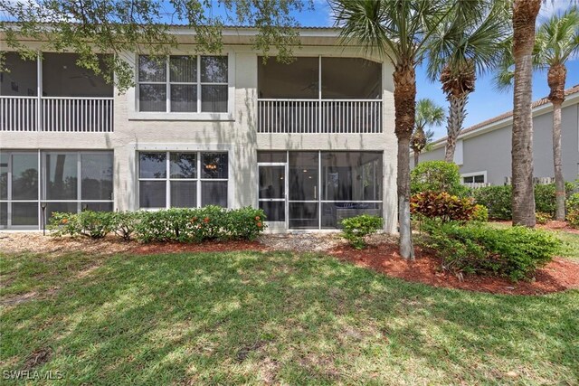 10115 Colonial Country Club Blvd Unit 2110, Fort Myers, FL 33913 - back of house featuring a lawn, a sunroom, and stucco siding