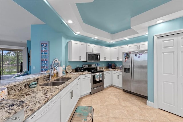 10115 Colonial Country Club Blvd Unit 2110, Fort Myers, FL 33913 - kitchen with appliances with stainless steel finishes, a sink, white cabinetry, recessed lighting, and light stone countertops