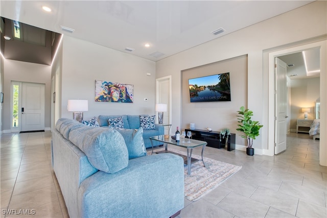 living area featuring baseboards, recessed lighting, and light tile patterned floors