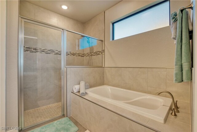 full bath with a stall shower, a garden tub, and recessed lighting