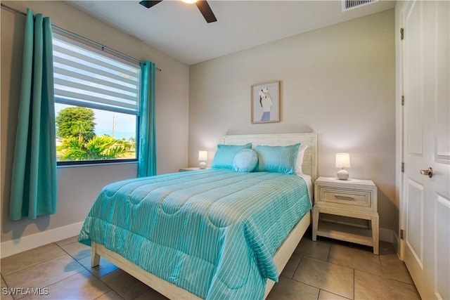bedroom with tile patterned flooring, baseboards, and ceiling fan