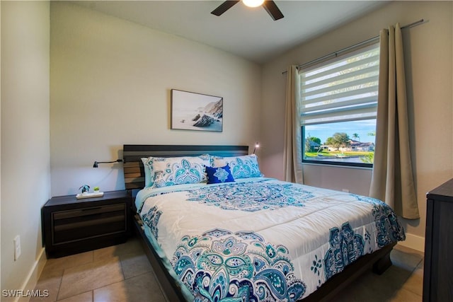 bedroom featuring baseboards, tile patterned flooring, and a ceiling fan