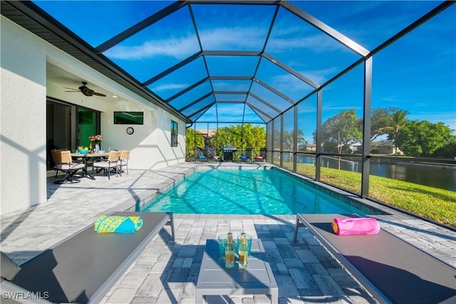 swimming pool with a patio area, a water view, and glass enclosure