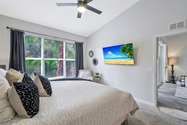 carpeted bedroom with baseboards, ceiling fan, and high vaulted ceiling