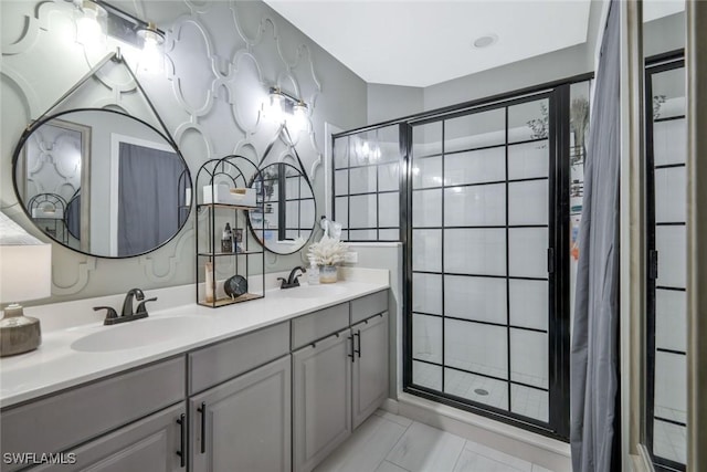 full bath featuring a shower stall and double vanity