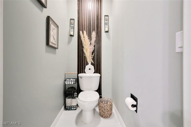 bathroom with tile patterned floors, baseboards, and toilet