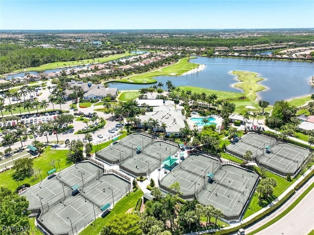aerial view of residential area featuring a nearby body of water and a golf course