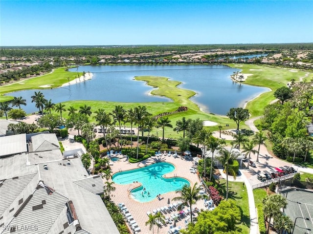 aerial view of residential area with a golf course, a nearby body of water, and a pool
