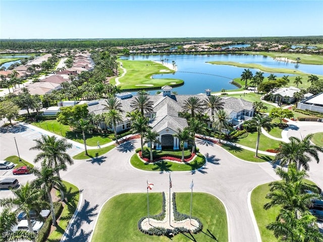 aerial view of residential area featuring a nearby body of water and a golf club