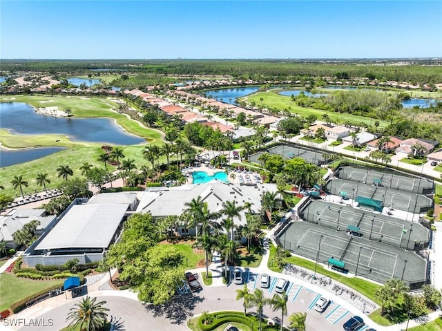 aerial perspective of suburban area featuring a large body of water and a golf club
