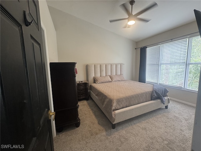 bedroom featuring vaulted ceiling, carpet, baseboards, and ceiling fan