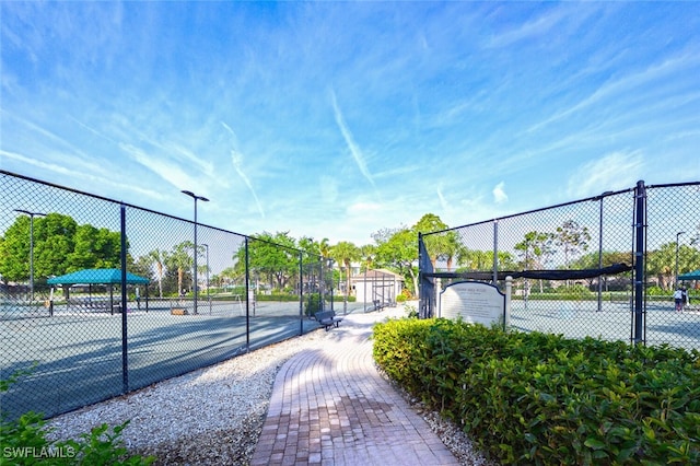 view of tennis court featuring fence