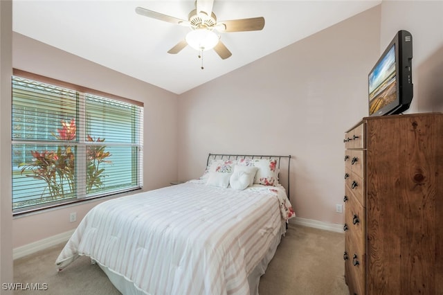 bedroom with carpet, baseboards, lofted ceiling, and ceiling fan
