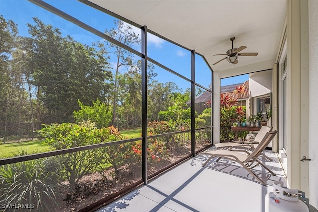 unfurnished sunroom featuring ceiling fan