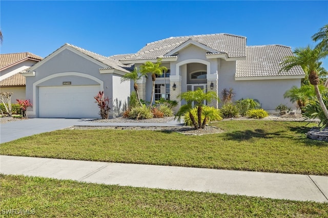 12721 Kelly Sands Way, Fort Myers, FL 33908 - mediterranean / spanish-style house featuring a tile roof, an attached garage, stucco siding, and concrete driveway