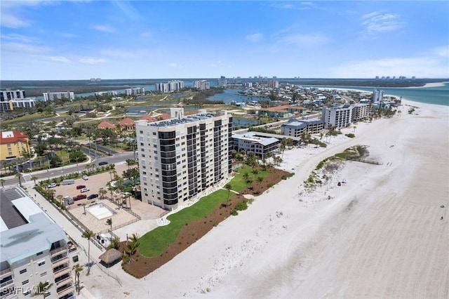 view of urban area featuring unending shoreline and apartment complex / building