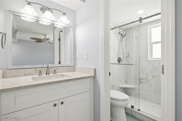 bathroom featuring a marble finish shower, a ceiling fan, toilet, and vanity