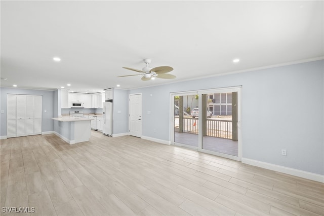 unfurnished living room featuring baseboards, ceiling fan, light wood finished floors, recessed lighting, and crown molding