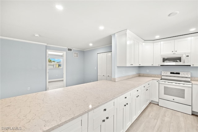 kitchen featuring white appliances, ornamental molding, light stone countertops, light wood-style flooring, and recessed lighting