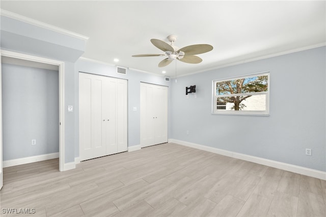 unfurnished bedroom with multiple closets, light wood finished floors, baseboards, crown molding, and recessed lighting