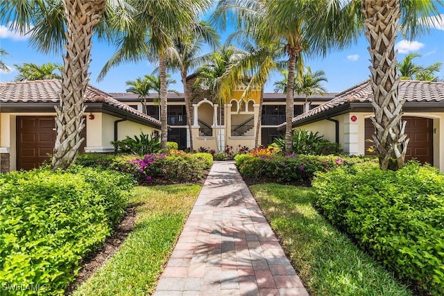 9510 Avellino Way Unit 1924, Naples, FL 34113 - view of front of house featuring stucco siding, an attached garage, and a tiled roof