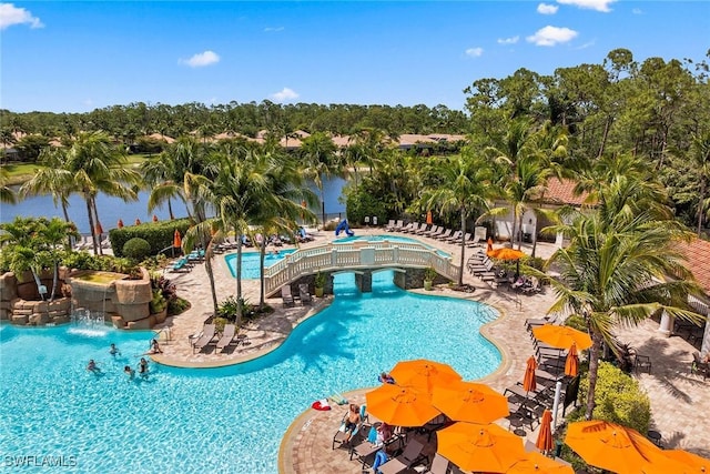 9510 Avellino Way Unit 1924, Naples, FL 34113 - community pool featuring a patio, view of wooded area, and a water view