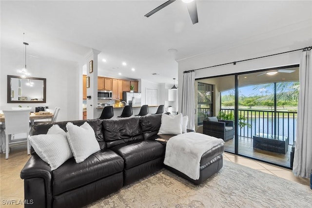 9510 Avellino Way Unit 1924, Naples, FL 34113 - living room with a ceiling fan, ornamental molding, recessed lighting, light tile patterned floors, and a water view