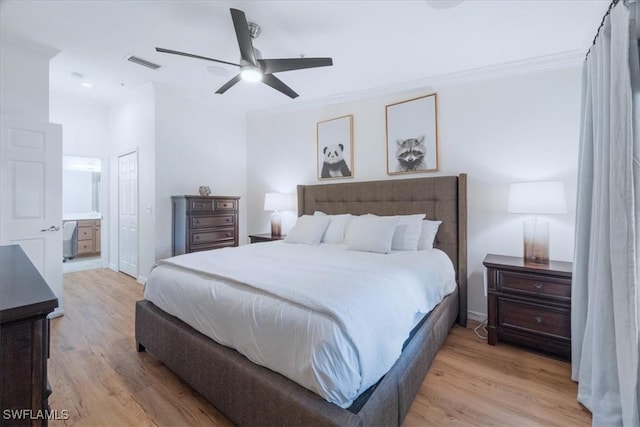 9510 Avellino Way Unit 1924, Naples, FL 34113 - bedroom featuring light wood finished floors, crown molding, connected bathroom, and ceiling fan