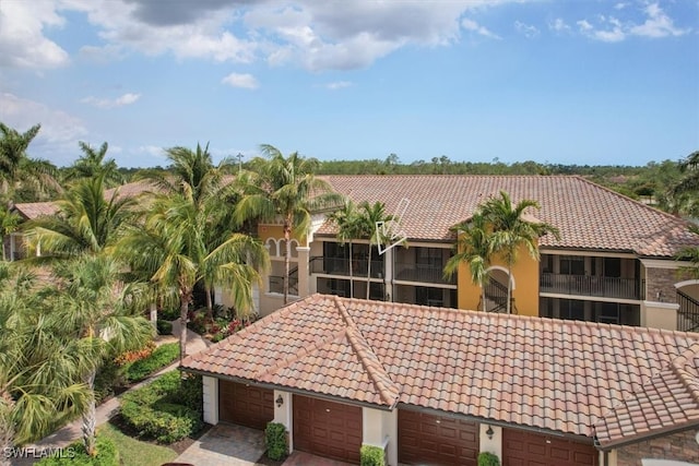 9510 Avellino Way Unit 1924, Naples, FL 34113 - view of front facade with a tiled roof, stucco siding, and an attached garage