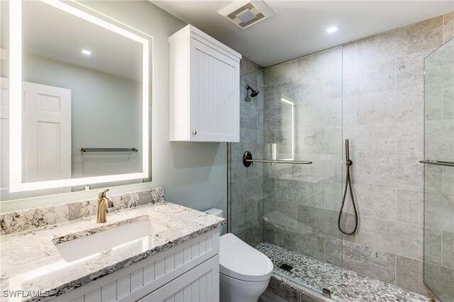 500 Saturn Ct Unit 48, Marco Island, FL 34145 - bathroom with tiled shower, toilet, vanity, and recessed lighting