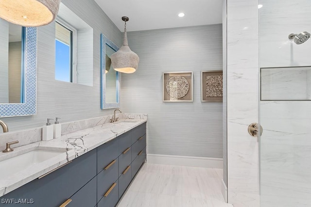 full bathroom featuring baseboards, a shower, and double vanity