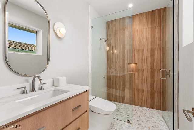 full bathroom featuring a stall shower, toilet, and vanity