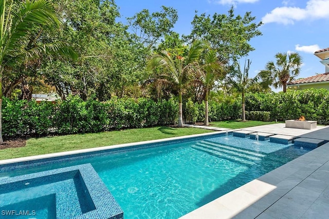 outdoor pool featuring an in-ground hot tub, a lawn, and a patio