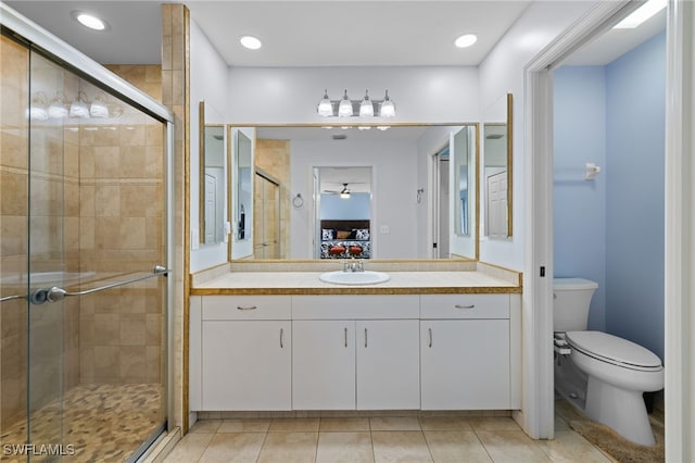 bathroom with a shower stall, tile patterned flooring, toilet, and ensuite bathroom