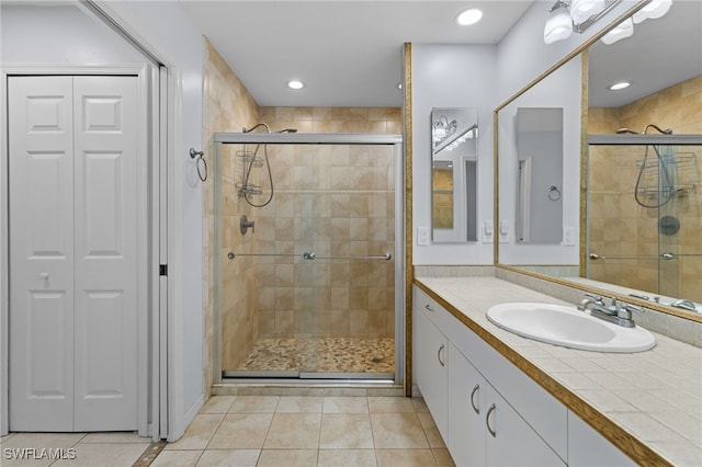 full bathroom with tile patterned floors, a shower stall, a closet, and recessed lighting
