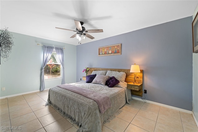 bedroom featuring light tile patterned flooring, baseboards, and a ceiling fan