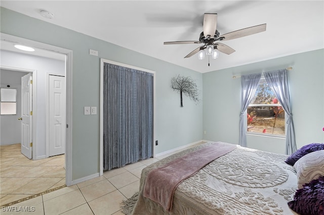 bedroom with light tile patterned floors, baseboards, and ceiling fan