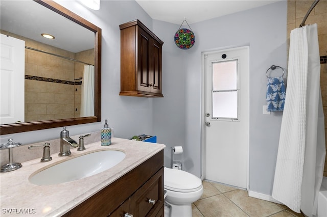 bathroom featuring tile patterned floors, vanity, toilet, and baseboards