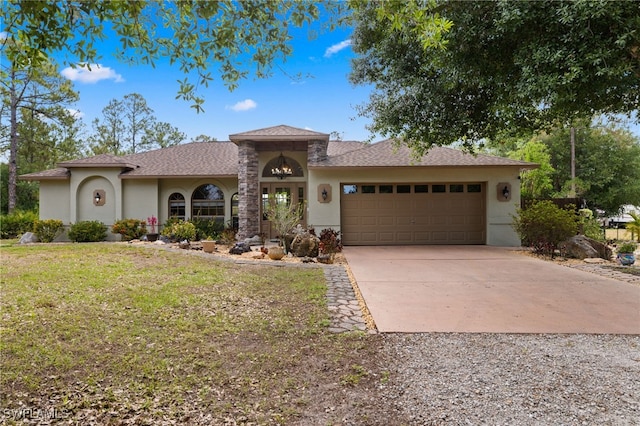 mediterranean / spanish-style house featuring concrete driveway, a garage, stucco siding, a front yard, and roof with shingles
