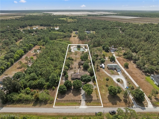 aerial view of property's location with a heavily wooded area and property boundaries highlighted