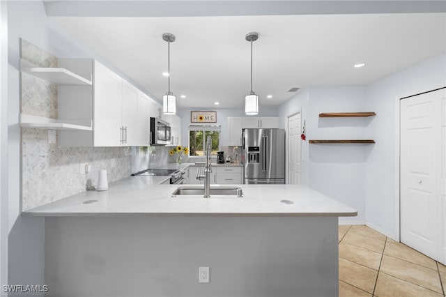 kitchen featuring open shelves, appliances with stainless steel finishes, a peninsula, light countertops, and white cabinetry