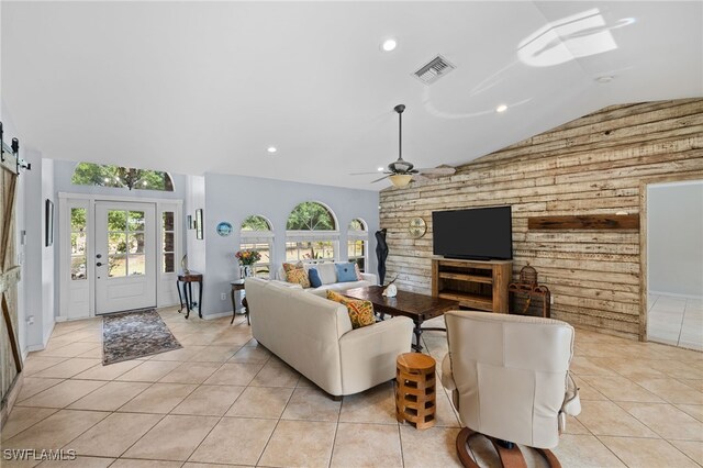 living room with vaulted ceiling, light tile patterned floors, ceiling fan, recessed lighting, and wood walls