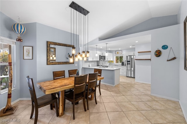 dining space featuring lofted ceiling, light tile patterned floors, recessed lighting, and baseboards
